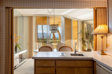 Perched above the shimmering lake and emerald fairways, 899