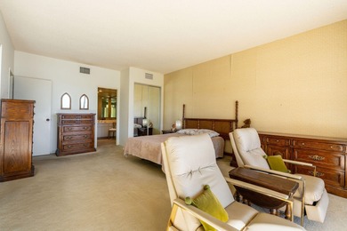 Perched above the shimmering lake and emerald fairways, 899