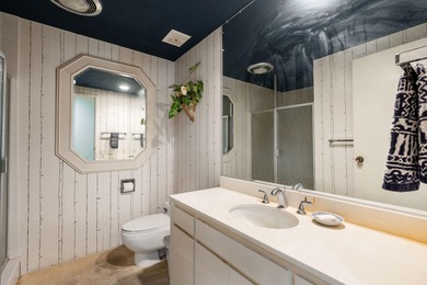 Perched above the shimmering lake and emerald fairways, 899