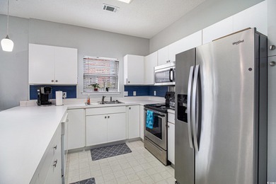 Enjoy effortless coastal living in this first floor, end-unit