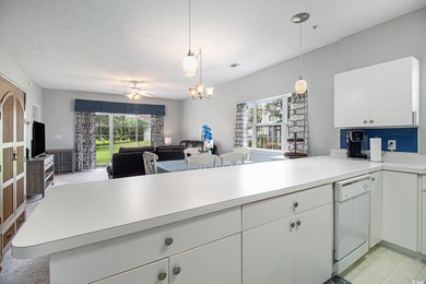 Enjoy effortless coastal living in this first floor, end-unit