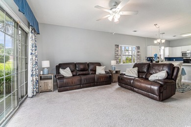 Enjoy effortless coastal living in this first floor, end-unit