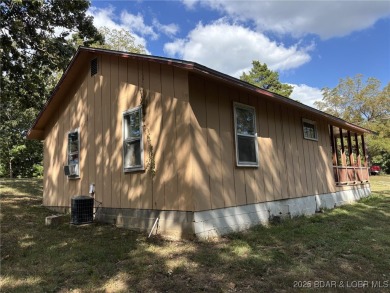 Start your Lake of the Ozarks adventure with this 1960 home full