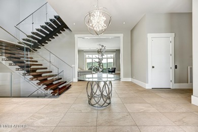 This magnificent lake home offers 6+ bedrooms, 8 full baths, 5