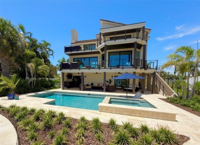 This exquisite custom waterfront residence features four