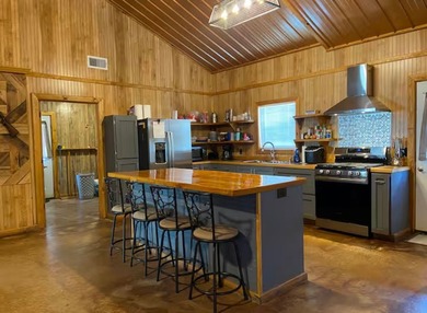 Enjoy lake living at its best in this spacious 4-bedroom, 2-bath