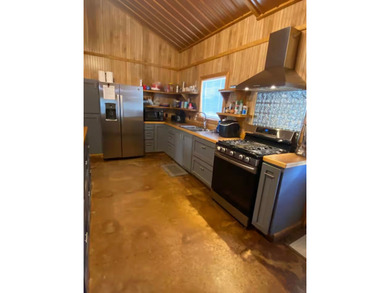 Enjoy lake living at its best in this spacious 4-bedroom, 2-bath