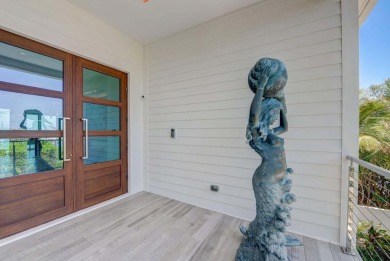 Ocean Ridge townhome, perched directly on the sand, showcases a