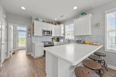 This meticulously maintained four-bedroom, three-bath waterfront