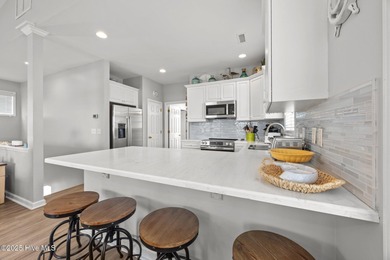 This meticulously maintained four-bedroom, three-bath waterfront