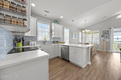 This meticulously maintained four-bedroom, three-bath waterfront