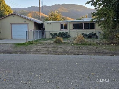 Situated on a nice corner lot, this older 2 bedroom, 1-1/2 bath