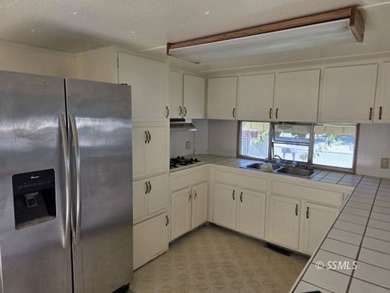 Situated on a nice corner lot, this older 2 bedroom, 1-1/2 bath