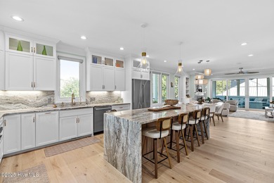 This gorgeous home in Kure Beach Village has 5 bedrooms, 5 1/2