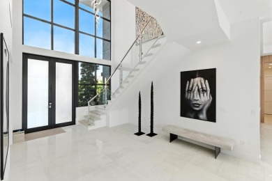 This extraordinary two-story waterfront estate is purpose-built