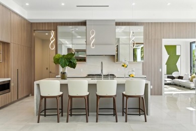 This extraordinary two-story waterfront estate is purpose-built