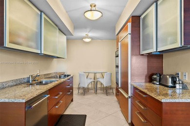 This luxurious beachfront unit features two bedrooms plus a den