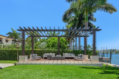 Experience unrivaled waterfront luxury at 210 Palm Avenue, a