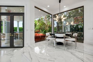 Experience breathtaking long lake views from this grand estate