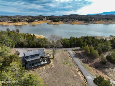 A beautiful lakefront home boasting mountain views, a boat dock