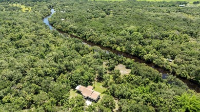 RIVERFRONT RETREAT on over 7 acres in Arcadia! Beautifully