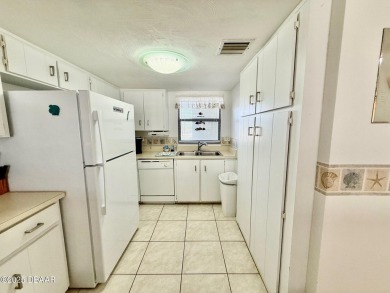Located in desirable Daytona Beach Shores this roomy end unit