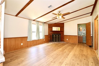 Tucked away on a quiet street sits this cozy half acre lot with