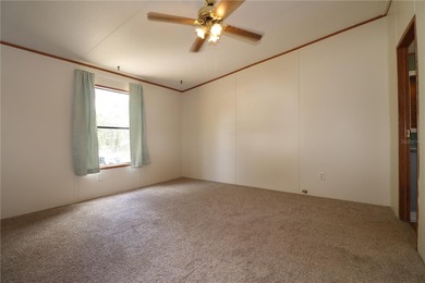 Tucked away on a quiet street sits this cozy half acre lot with