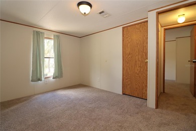 Tucked away on a quiet street sits this cozy half acre lot with