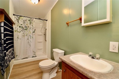 Tucked away on a quiet street sits this cozy half acre lot with