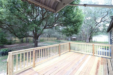 Tucked away on a quiet street sits this cozy half acre lot with