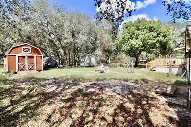 Tucked away on a quiet street sits this cozy half acre lot with
