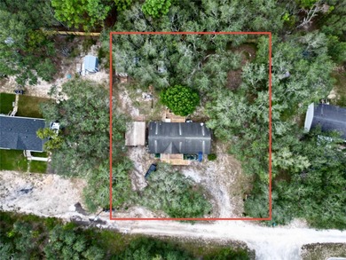 Tucked away on a quiet street sits this cozy half acre lot with