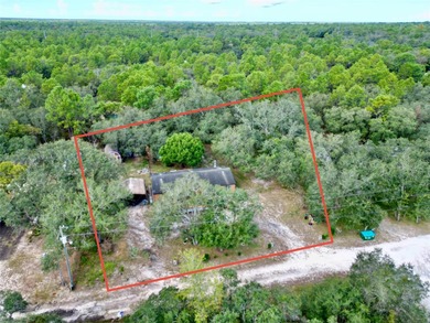 Tucked away on a quiet street sits this cozy half acre lot with