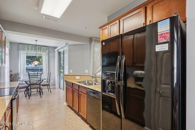 Welcome to this charming ground-level, end unit condo in the