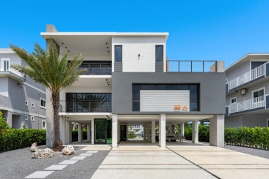 A modern sanctuary on the water, this newly built Key Largo