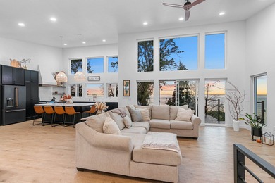 Experience modern-luxury lakeside living in this stunning home