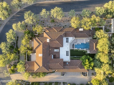 Welcome to 10163 E. Hualapai Drive, a timeless estate nestled in
