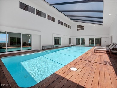 Welcome to a stunning coastal-modern beachfront estate on