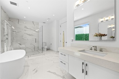 Coastal charm meets elevated elegance at this four-level, modern