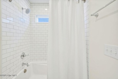 Welcome to 1408 E Beach Drive, where every sunrise feels close