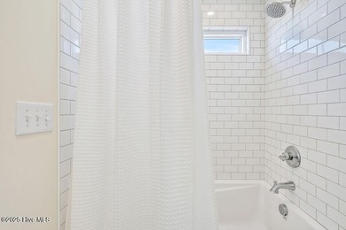 Welcome to 1408 E Beach Drive, where every sunrise feels close