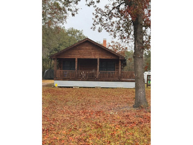 ONE OF A KIND! This beautifully constructed LOG CABIN style home