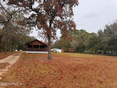 ONE OF A KIND! This beautifully constructed LOG CABIN style home