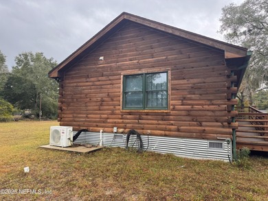 ONE OF A KIND! This beautifully constructed LOG CABIN style home