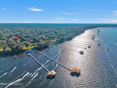 A distinguished riverfront home privately set beyond a majestic