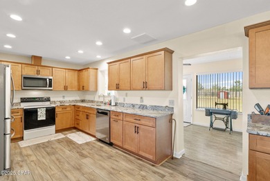 Welcome to this charming 2-bedroom, 2-bath home on a half-acre