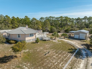 This 1.12 acre estate, is one block from Carrabelle Beach, and
