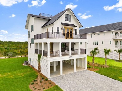 Introducing a striking four-level coastal haven that rises above