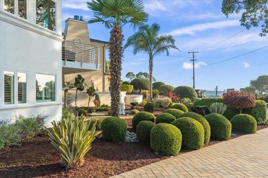 Perched on a spacious corner lot steps from beach access-this